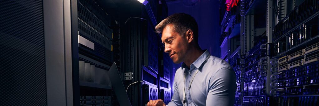 Employee checking hardware equipment in server room